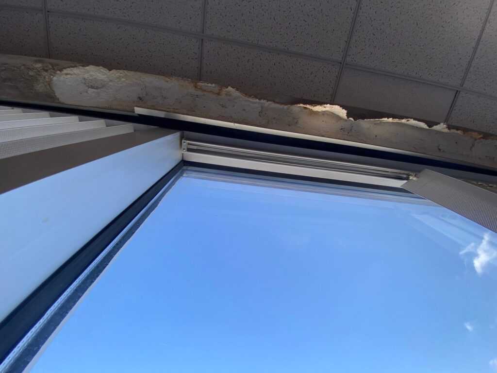 Photo shows window with water damage